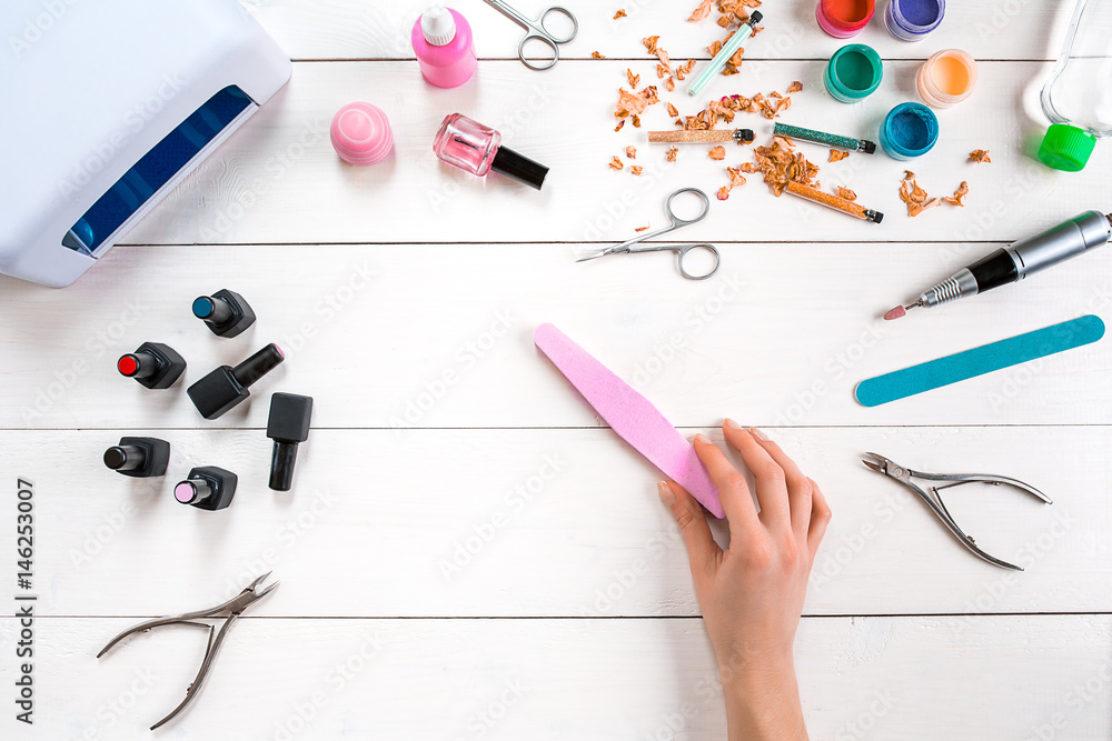 Manicure set and nail polish on wooden background Manicure set and nail polish on wooden background
