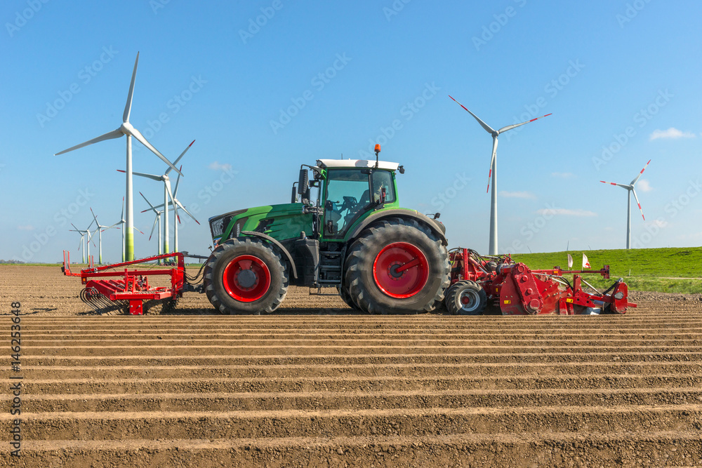 Fototapeta Landtechnik - Traktor auf dem Acker beim Kartoffelanbau - 7099