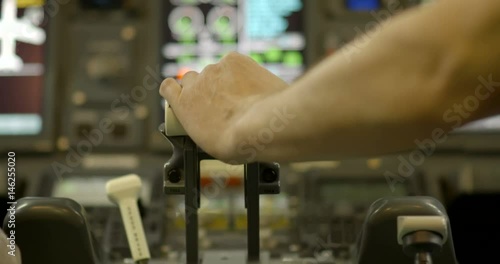 Detail shot of airline pilot's hand pushing throttle in the cockpit