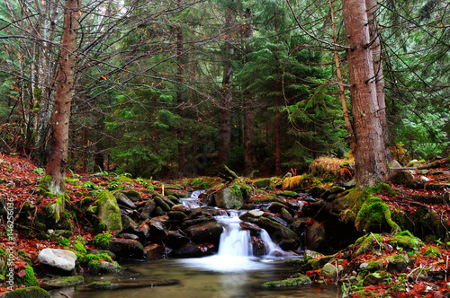 Mountain river with cascade in late Autumn