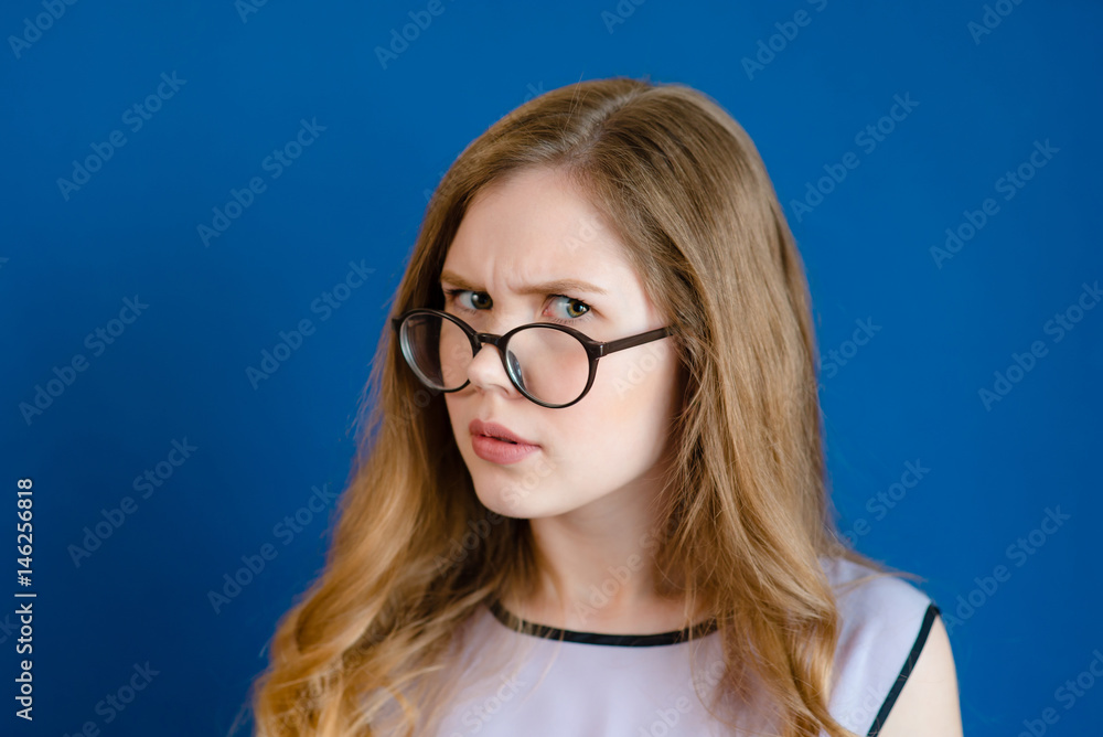 A girl with glasses is surprised