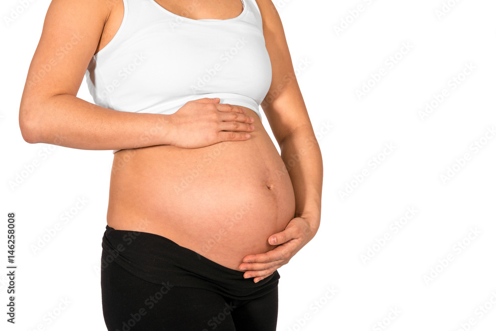Pregnant woman embracing her bare belly with white background