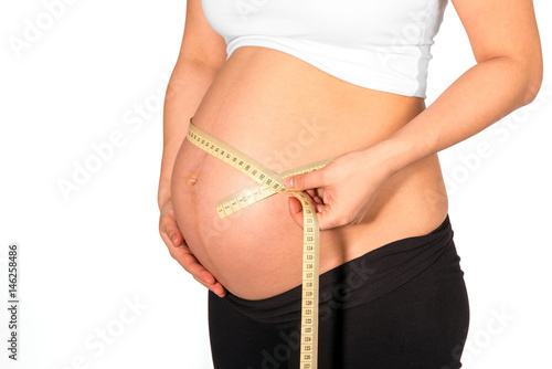 Tapeline wrapped around bare belly of pregnant woman