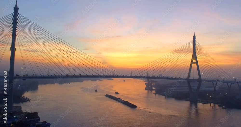 aerial view of bhumiphol bridge and container ship in chaopraya river at morning aerial view of bhumiphol bridge and container ship in chaopraya river at morning