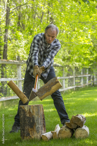 Caucasian man chopping wood