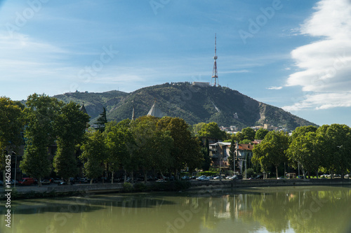 View of mount Mtatsminda through the Kura river in Tbilisi, Georgia.