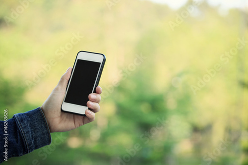 closeup of hands using smartphone taking photo outdoor