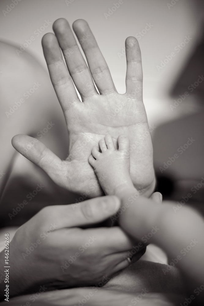 father kisses the feet of a newborn son father kisses the feet of a newborn son