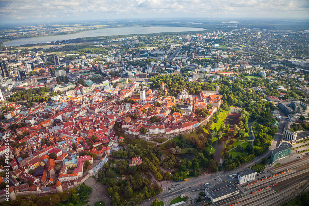 Aerial view from helicopter of red roofs and parks of old town of Tallinn, Estonia. Summer time