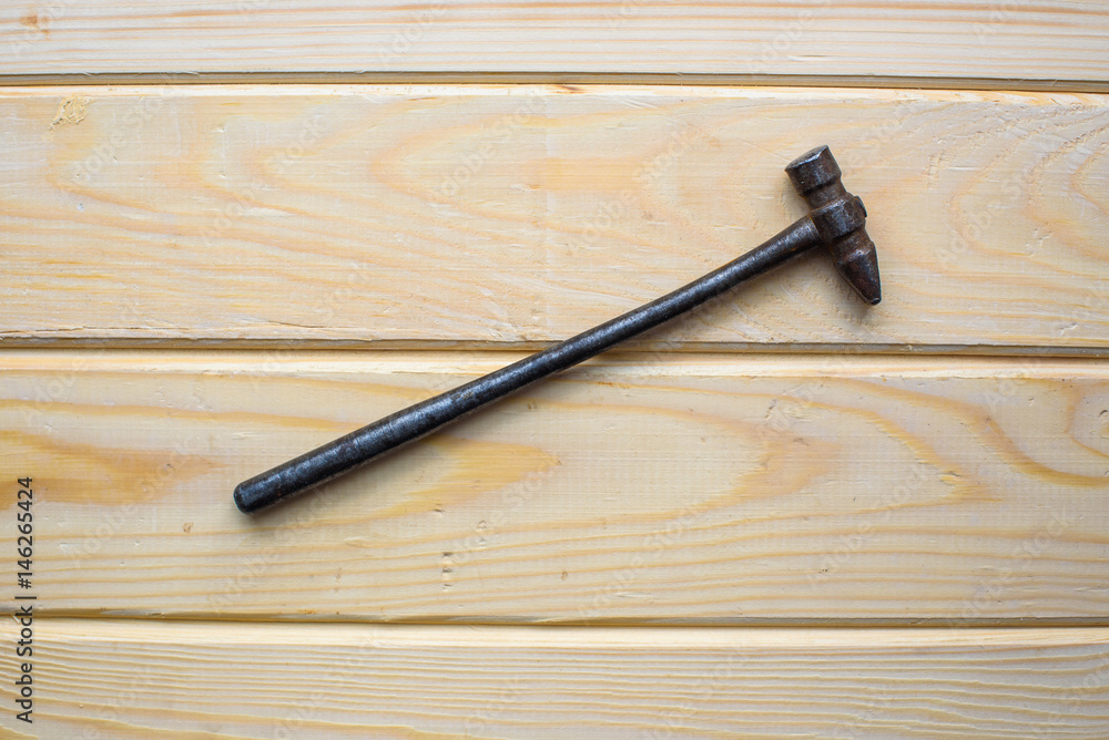 Old rusty hammer on wood background. Old rusty industrial home tools Old rusty hammer on wood background. Old rusty industrial home tools