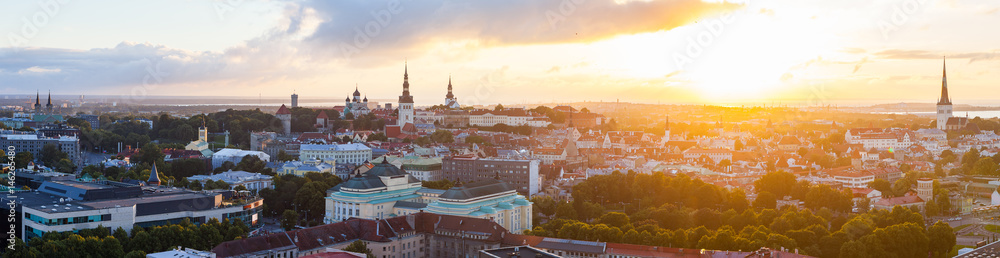 Colorful sunset over towers of old town of Tallinn, Estonia. Ultra wide panoramic view