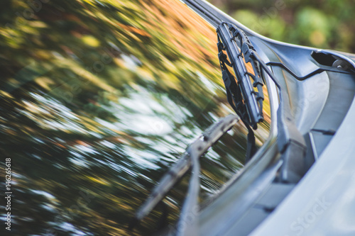 Close-up wiper blade on the car glass with shallow depth of field