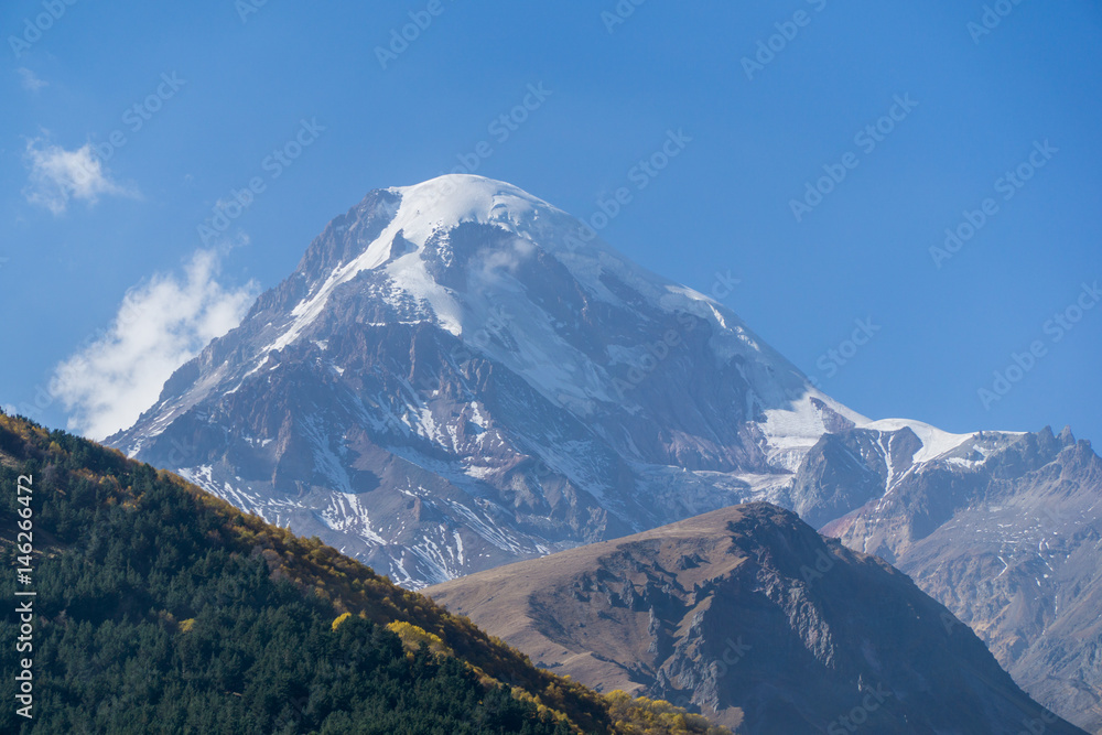 Mount Kazbek, view from Stepantsminda town in Georgia in sunny weather.