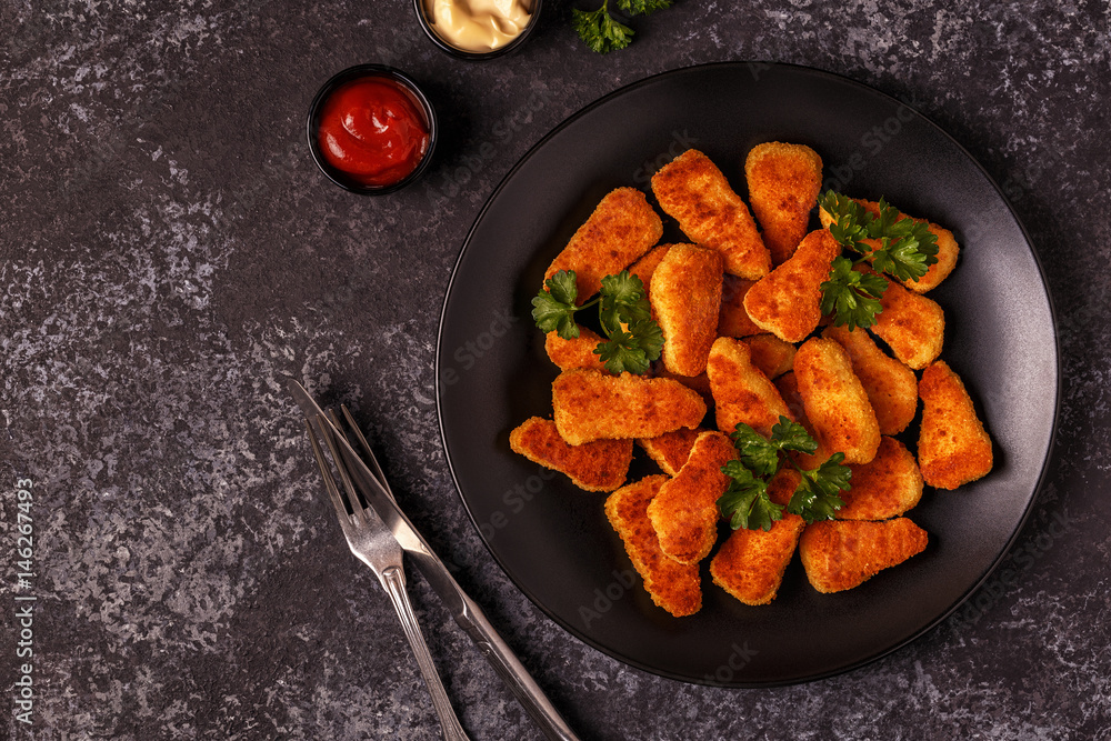 Chicken naggets with sauces on dark background. Chicken naggets with sauces on dark background.