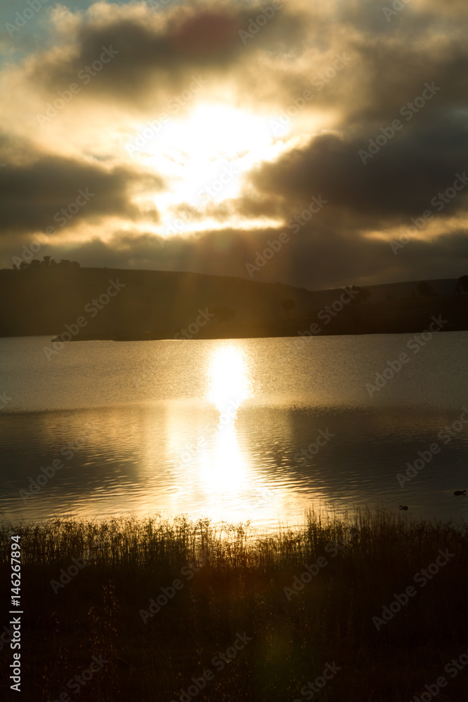 sunrise over calm lake