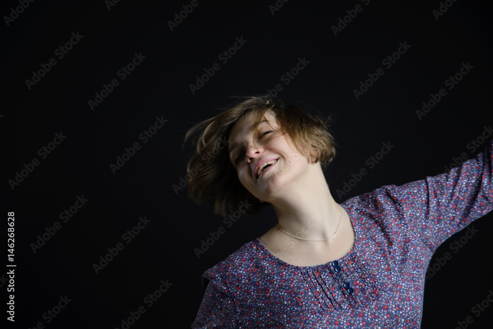 young pretty woman dancing, happy girl dancing on dark background young pretty woman dancing, happy girl dancing on dark background