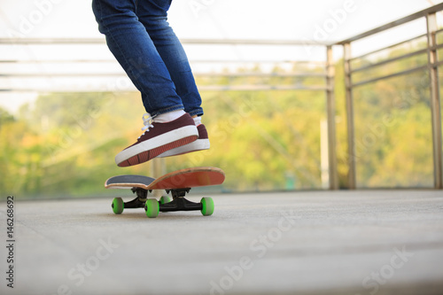 skateboarder legs skateboarding at skatepark