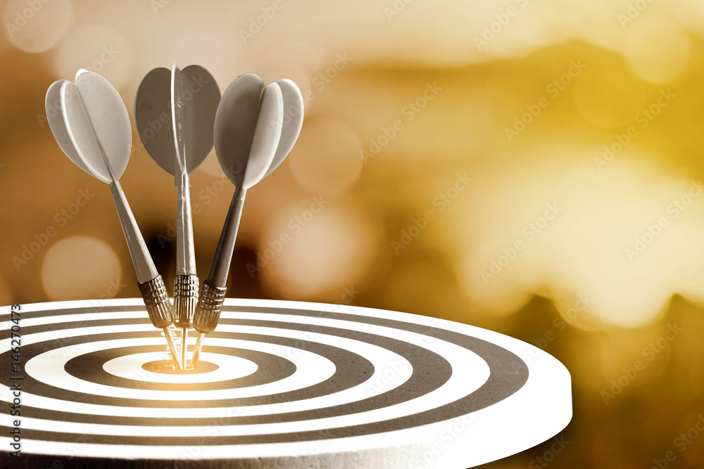 Circular target marked with numbers and dart with defocused or blurred bokeh background. An idea of business targets, audience, market, group, analysis, risk, rate, area, value Circular target marked with numbers and dart with defocused or blurred bokeh background. An idea of business targets, audience, market, group, analysis, risk, rate, area, value