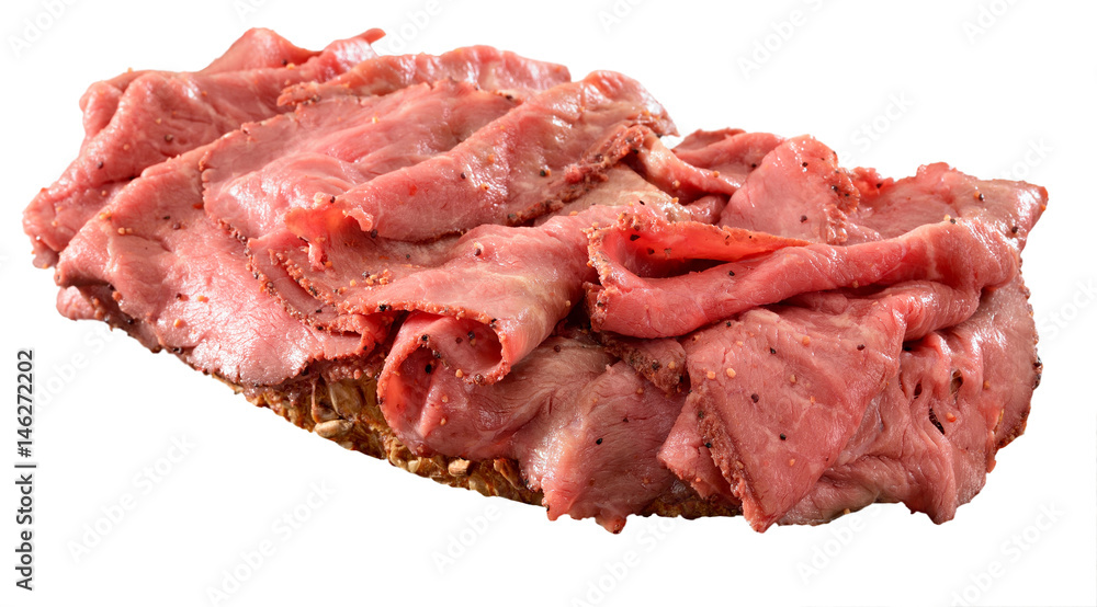 Thinly sliced rare roast beef open sandwich on wholegrain bread. Isolated on white.