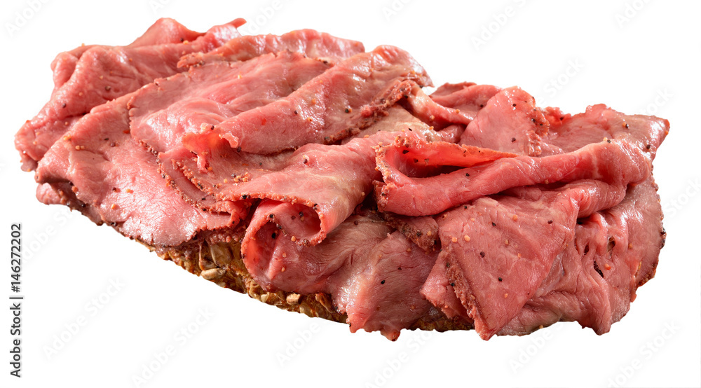 Thinly sliced rare roast beef open sandwich on wholegrain bread. Isolated on white. Thinly sliced rare roast beef open sandwich on wholegrain bread. Isolated on white.