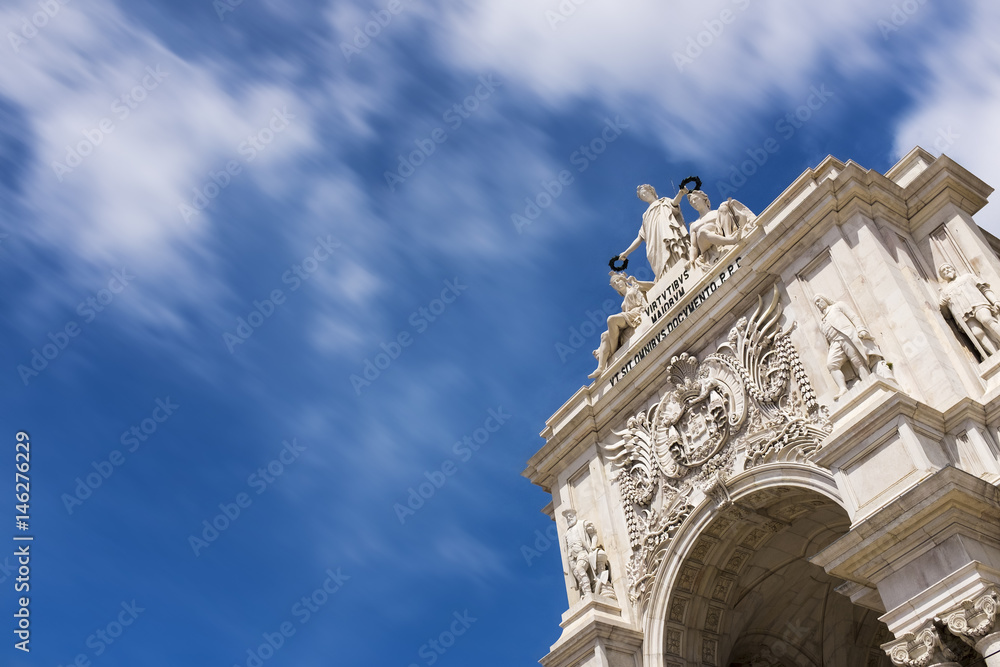 Detail of the Triumphal Arch in the Terreiro do Paco Square against a blue sky in Lisbon, Portugal