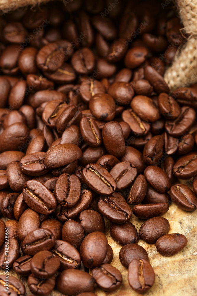 Coffee beans closeup on wooden table. Selective focus Coffee beans closeup on wooden table. Selective focus