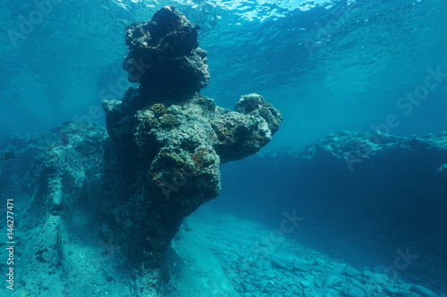 Pacific ocean natural rock formation underwater carved by the waves in the outer reef of Huahine island, French Polynesia