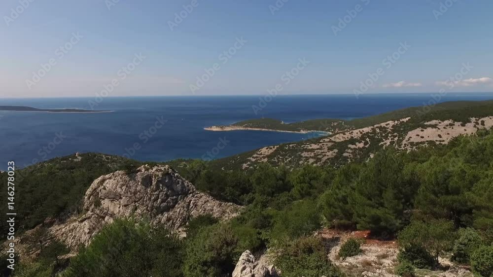 Aerial view from a rocking mountains with a blue sea on a background Aerial view from a rocking mountains with a blue sea on a background