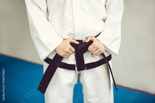 hands on the black belt and kimono. the martial art of Tae Kwon do and karate.