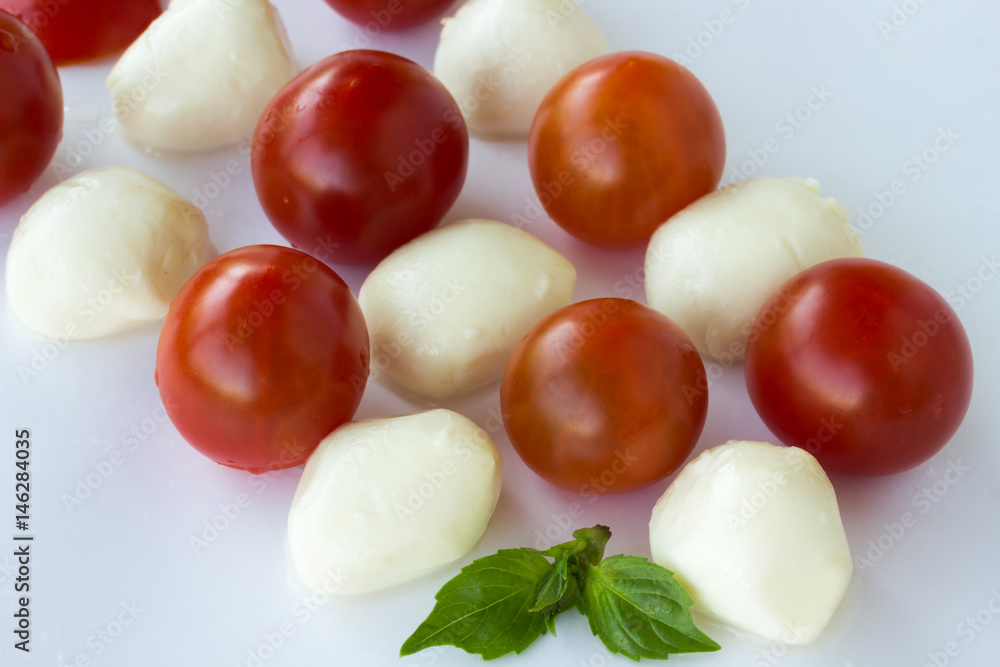 Mozzarella balls and tomato on a white background. Mozzarella balls and tomato on a white background.