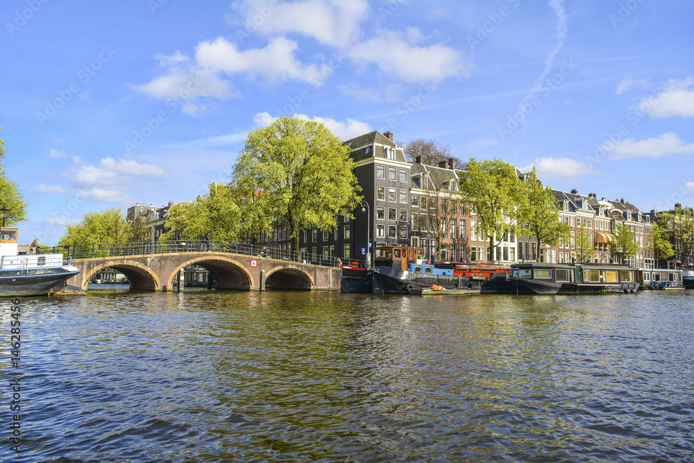 Naklejka premium Amsterdam city with boats on canal, Netherlands