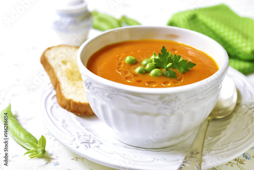 Carrot creamy soup with green pea.