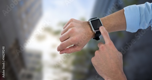 Hands with watch against blurry buildings and sky © vectorfusionart