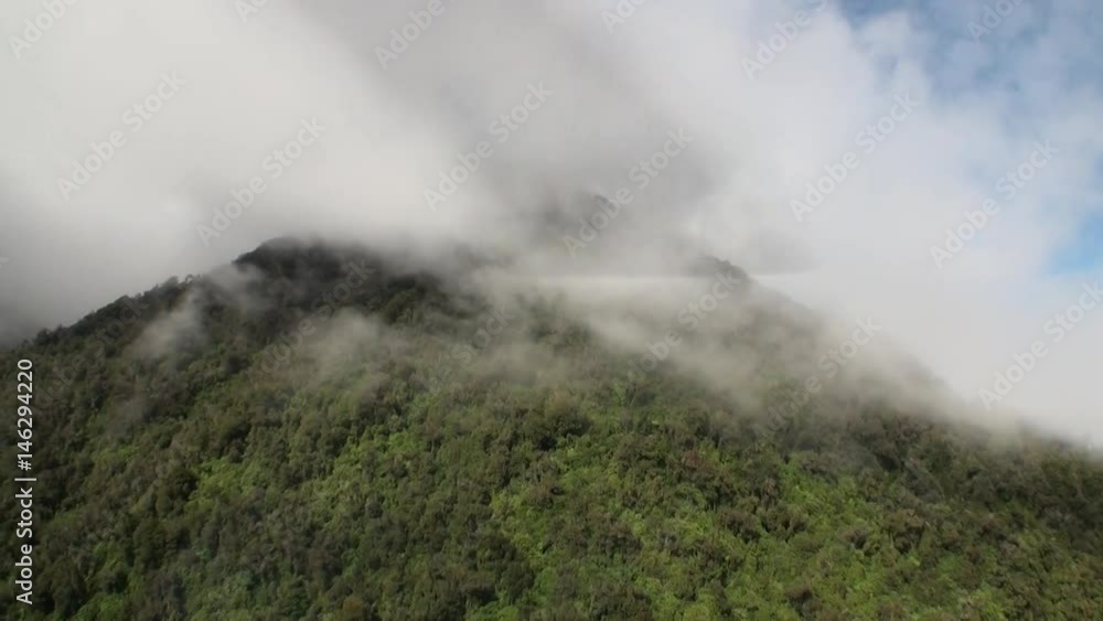 Green mountain panorama view from helicopter window in New Zealand. Scenic peaks and ridges. Beautiful background of amazing nature. Travel and tourism in the world of wildlife. Green mountain panorama view from helicopter window in New Zealand. Scenic peaks and ridges. Beautiful background of amazing nature. Travel and tourism in the world of wildlife.