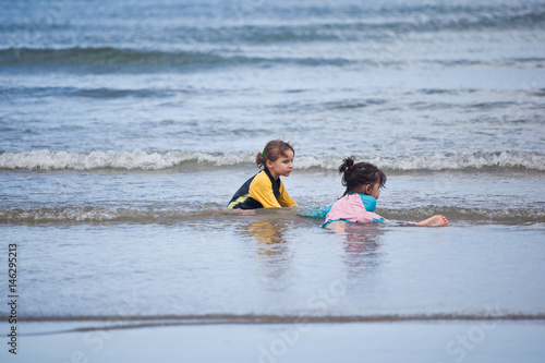 Little girls playing on the beach, family beach vacation