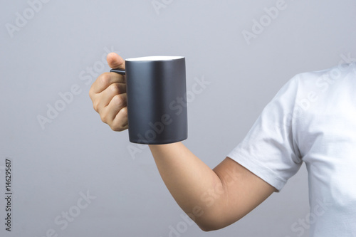 Woman hand holding black mug