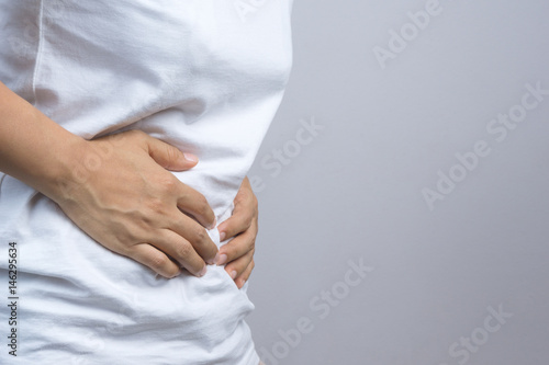 Woman putting her hands for belly or stomach ache