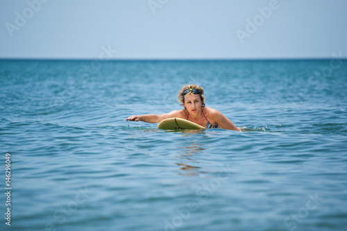The woman surfing at the sea  summer vacation