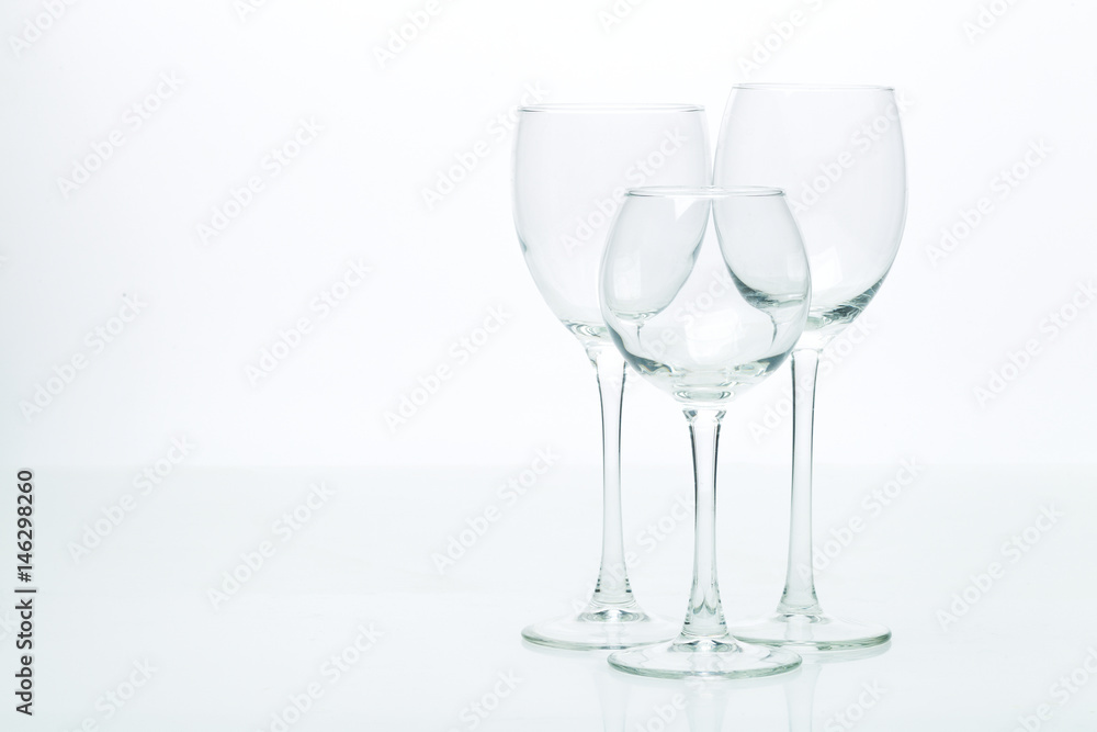 Grapes and three glasses for wine on a white background, studio light