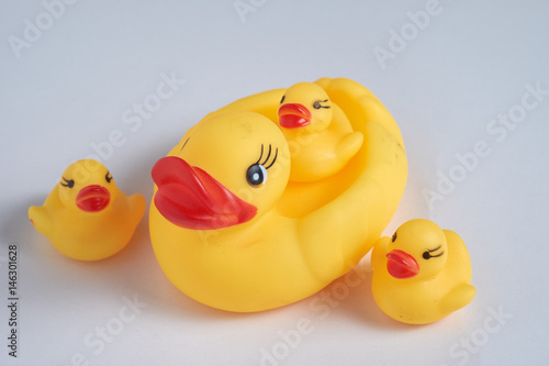 Yellow toy rubber ducks family. on white background.