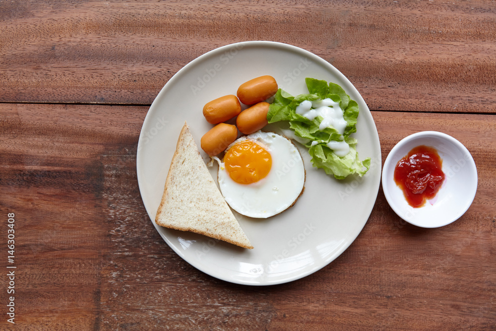 Quick and easy breakfast, fried eggs with sausages, toast and salad. Quick and easy breakfast, fried eggs with sausages, toast and salad.