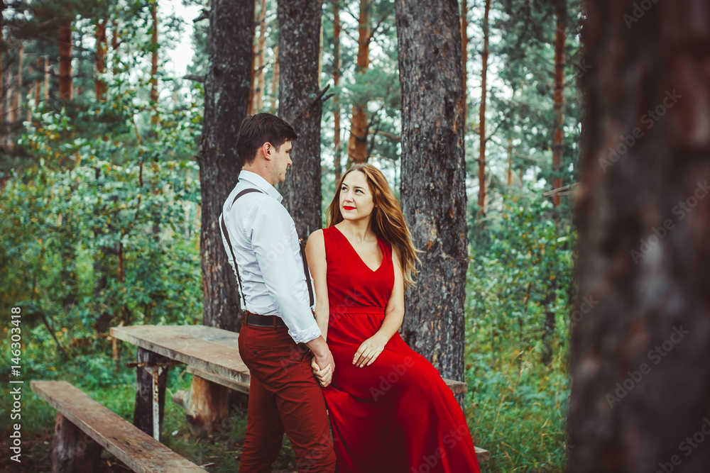 loving couple in the forest on the bench loving couple in the forest on the bench