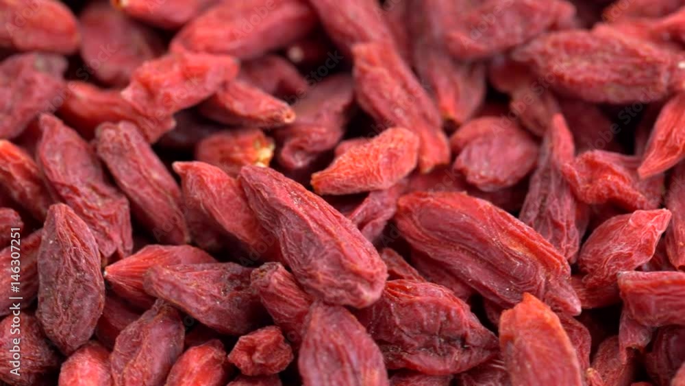 Dried goji berries - turning macro background Dried goji berries - turning macro background