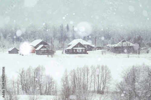 rural landscape with small houses on a snowy day © kichigin19