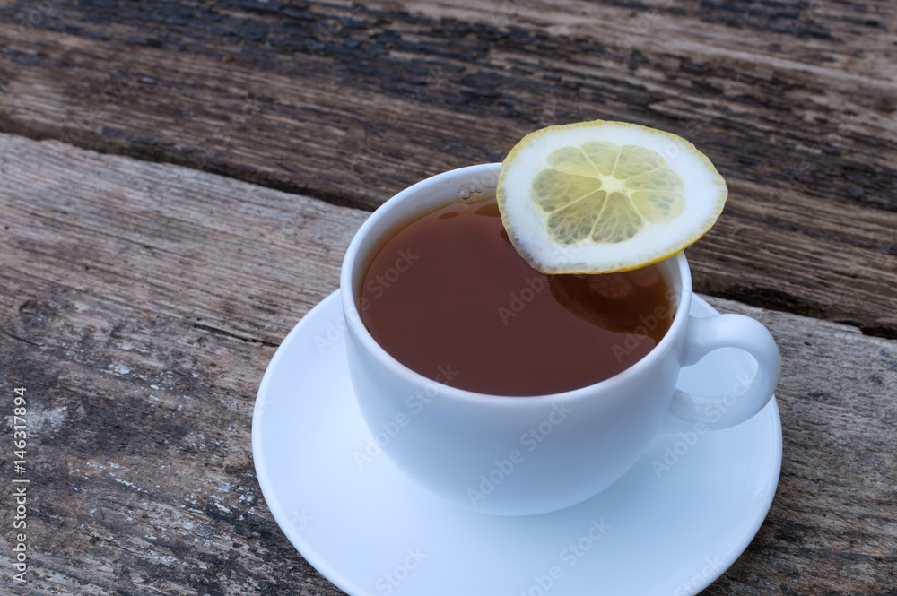 cup of tea with lemon on wooden background cup of tea with lemon on wooden background