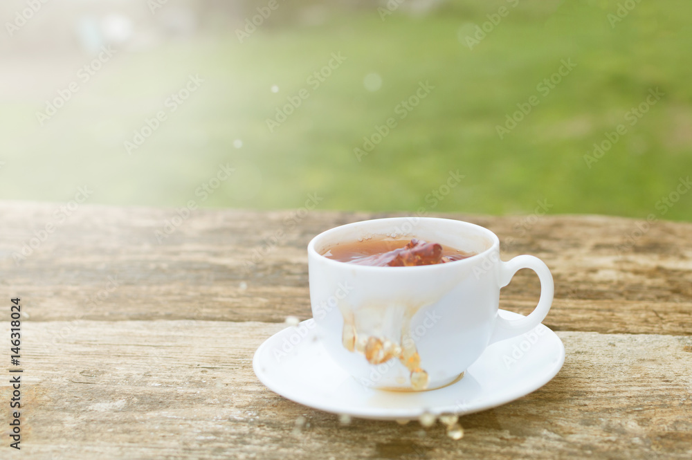 cup of tea with lemon on wooden background