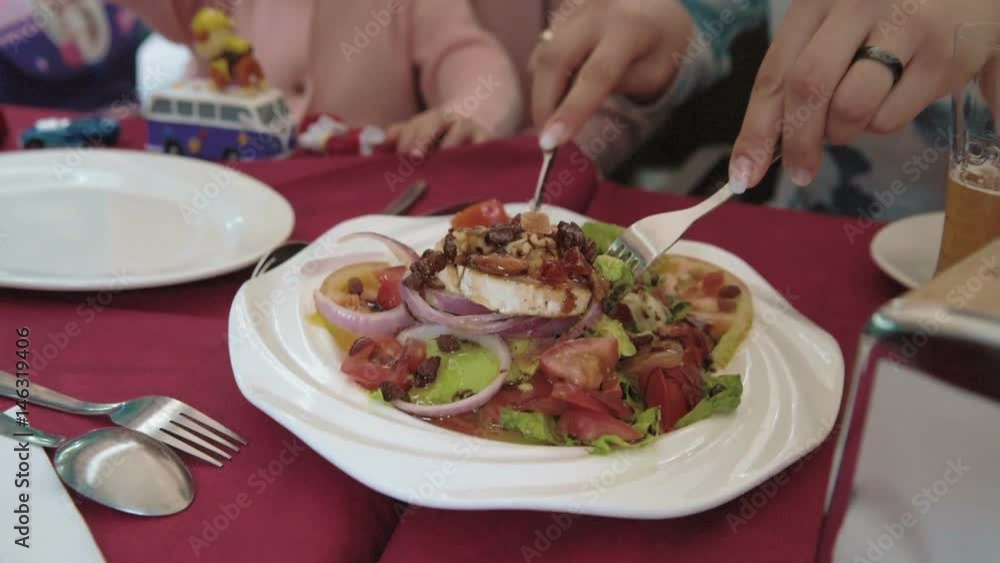 Dinner at wooden beach table served with fruit, salads Dinner at wooden beach table served with fruit, salads