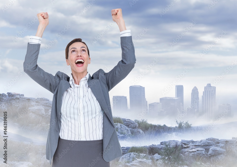 Business woman cheering on mountain against misty skyline Business woman cheering on mountain against misty skyline