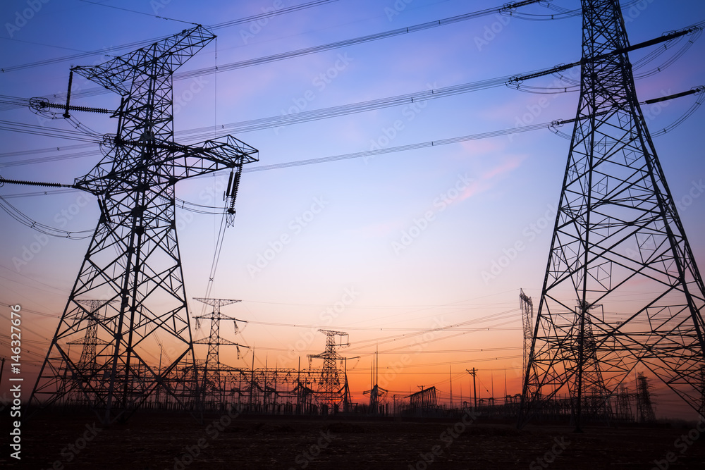 The silhouette of the evening electricity transmission pylon