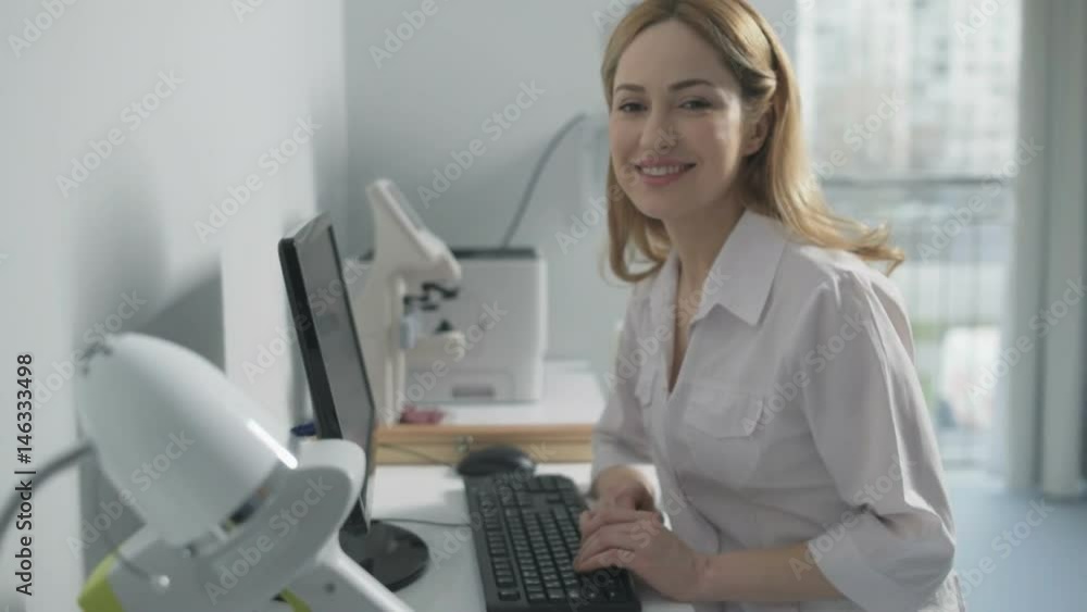 Cheerful medical professional sitting at computer Cheerful medical professional sitting at computer